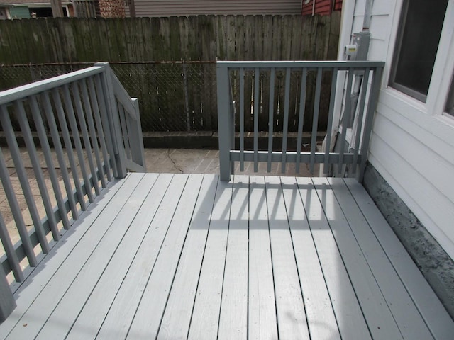 wooden terrace featuring fence