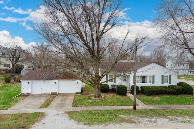 108 N Chatham St, Danvers, IL 61732 - view of front of property featuring an outbuilding, a garage, a front lawn, and concrete driveway