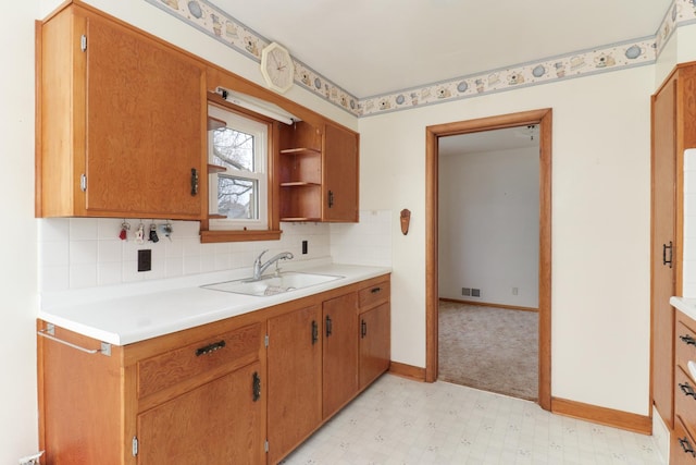 108 N Chatham St, Danvers, IL 61732 - kitchen with light countertops, decorative backsplash, a sink, visible vents, and light floors