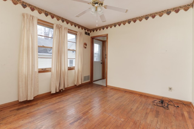 108 N Chatham St, Danvers, IL 61732 - empty room featuring light wood finished floors, baseboards, visible vents, and a ceiling fan