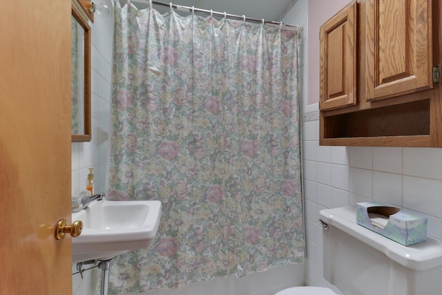 108 N Chatham St, Danvers, IL 61732 - bathroom featuring tile walls, toilet, curtained shower, and a sink