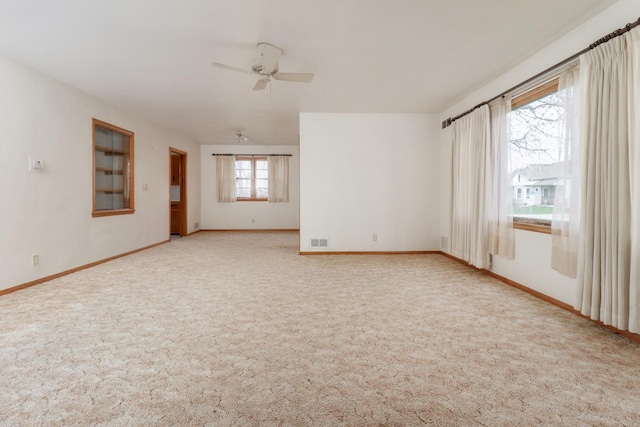 108 N Chatham St, Danvers, IL 61732 - spare room featuring baseboards, ceiling fan, visible vents, and carpet