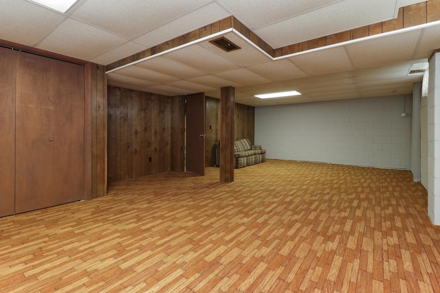 108 N Chatham St, Danvers, IL 61732 - finished basement featuring concrete block wall, visible vents, a drop ceiling, and light wood finished floors