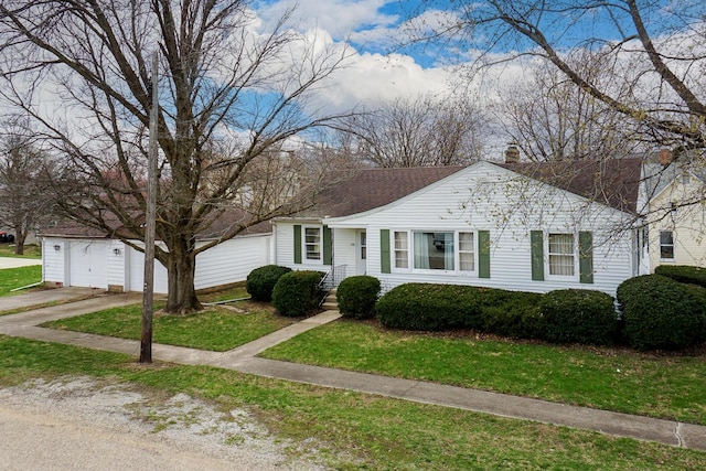 108 N Chatham St, Danvers, IL 61732 - view of front of house with a garage, a front lawn, driveway, an outbuilding, and a shingled roof