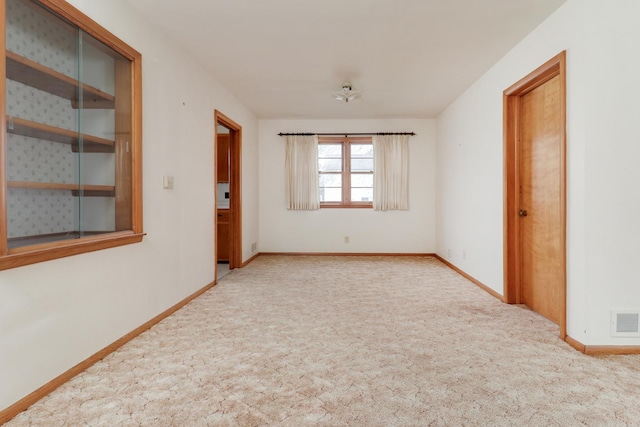108 N Chatham St, Danvers, IL 61732 - spare room featuring baseboards, visible vents, and carpet