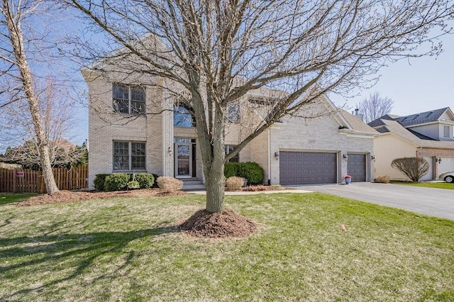 traditional home featuring brick siding, a front yard, fence, and aphalt driveway