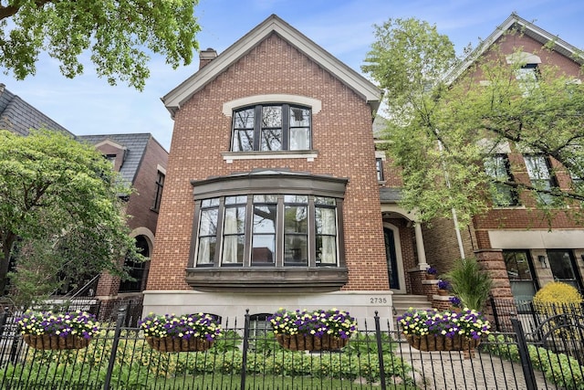 2735 N Dayton St, Chicago, IL 60614 - view of front facade featuring a fenced front yard, brick siding, and a chimney