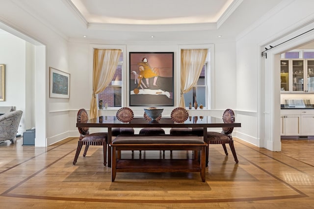 2735 N Dayton St, Chicago, IL 60614 - dining space with ornamental molding, a tray ceiling, a wainscoted wall, a decorative wall, and light wood-type flooring