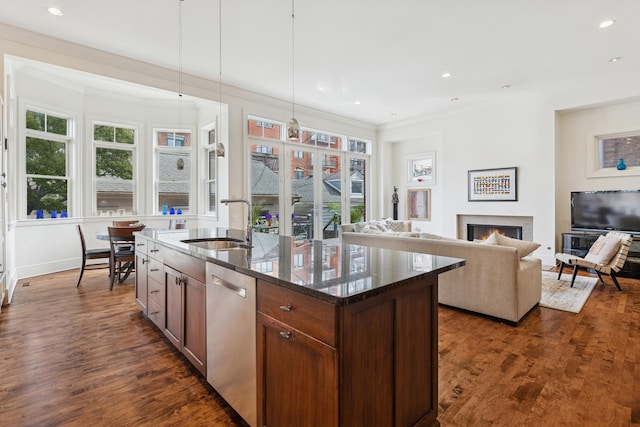 2735 N Dayton St, Chicago, IL 60614 - kitchen featuring a sink, stainless steel dishwasher, a warm lit fireplace, dark stone counters, and dark wood-style flooring
