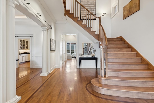 2735 N Dayton St, Chicago, IL 60614 - stairs featuring a towering ceiling, hardwood / wood-style flooring, decorative columns, crown molding, and baseboards