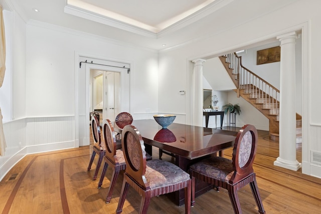 2735 N Dayton St, Chicago, IL 60614 - dining room with ornate columns, light wood-style floors, stairway, a tray ceiling, and ornamental molding