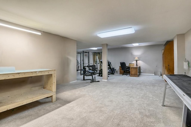 finished below grade area featuring a desk and carpet floors
