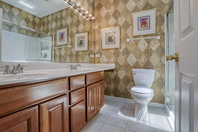bathroom featuring tile patterned floors, toilet, a tile shower, and double vanity