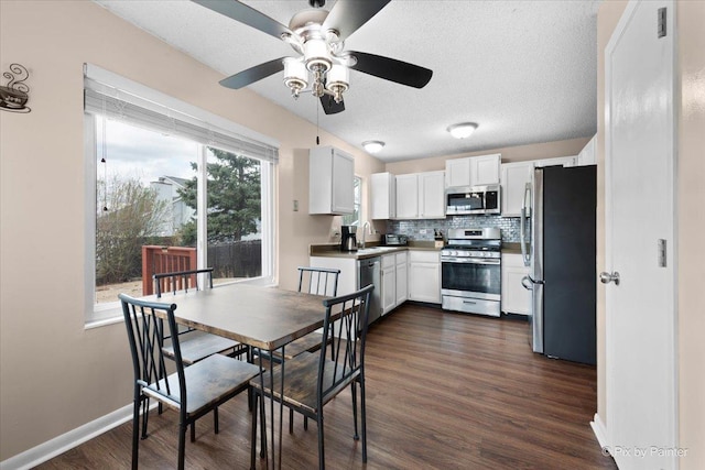 1832 Schmale Ct, Glendale Heights, IL 60139 - kitchen with white cabinets, dark wood finished floors, backsplash, ceiling fan, and appliances with stainless steel finishes