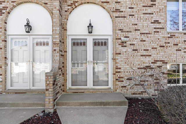 doorway to property with brick siding and french doors