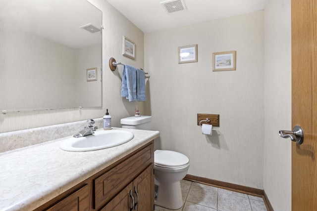 bathroom with visible vents, toilet, vanity, and tile patterned floors