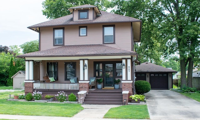 447 S State St, Monticello, IL 61856 - american foursquare style home with a porch, a shingled roof, and a detached garage