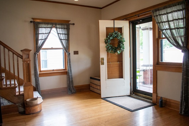 447 S State St, Monticello, IL 61856 - entrance foyer with light wood-style flooring, crown molding, baseboards, and stairs