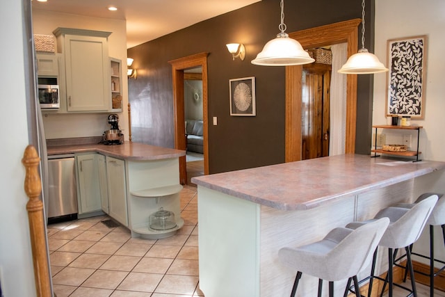 447 S State St, Monticello, IL 61856 - kitchen featuring light tile patterned floors, open shelves, decorative light fixtures, appliances with stainless steel finishes, and a peninsula