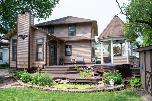 447 S State St, Monticello, IL 61856 - back of property featuring a chimney, a wooden deck, a hot tub, and a gazebo