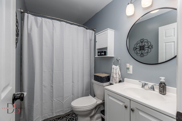 bathroom featuring toilet, vanity, and a shower with shower curtain