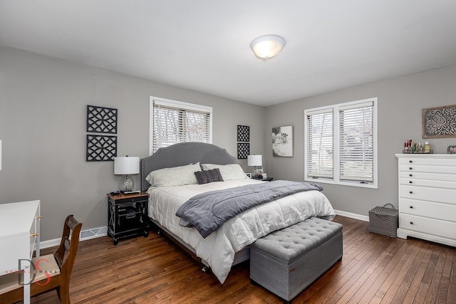 bedroom featuring dark wood-style floors, multiple windows, and baseboards