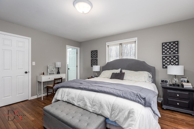 bedroom with hardwood / wood-style floors and baseboards