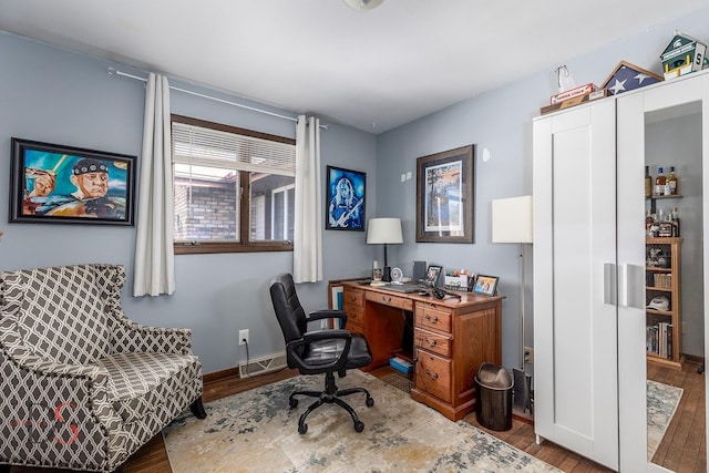office space with baseboards and wood finished floors