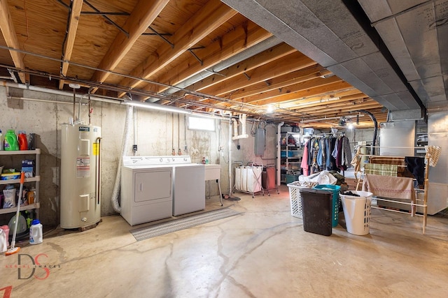 basement featuring electric water heater and washer and dryer