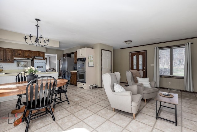living area with visible vents and an inviting chandelier