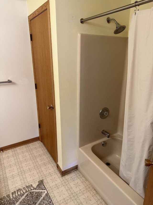 full bathroom with tile patterned floors, baseboards, and shower / tub combo with curtain