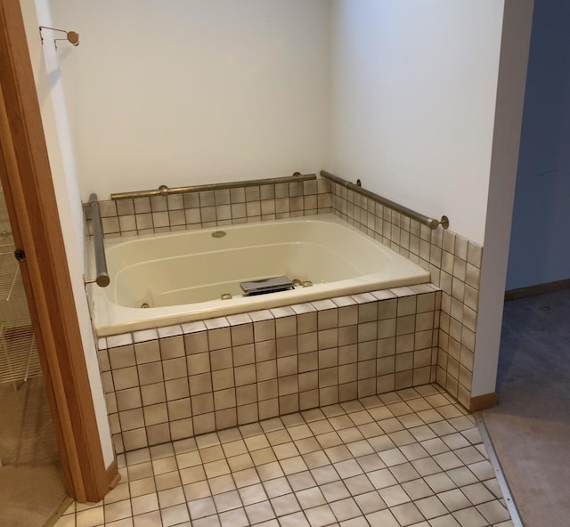 bathroom with a jetted tub and tile patterned flooring