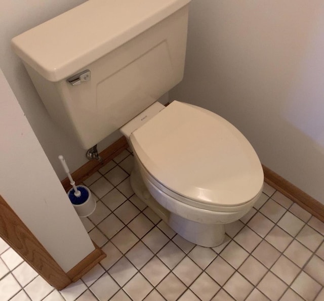 bathroom featuring tile patterned flooring, toilet, and baseboards