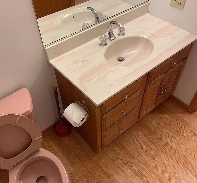 187 Hilltop Dr, Lake In The Hills, IL 60156 - half bath with toilet, wood finished floors, vanity, and baseboards