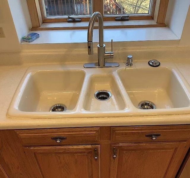 details featuring light countertops, a sink, and brown cabinets