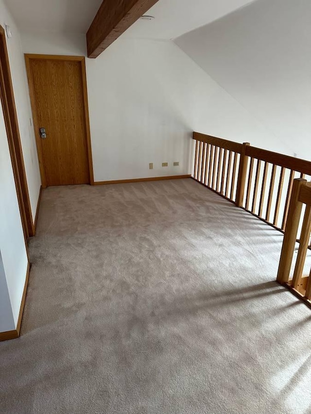 additional living space with carpet, lofted ceiling, and baseboards
