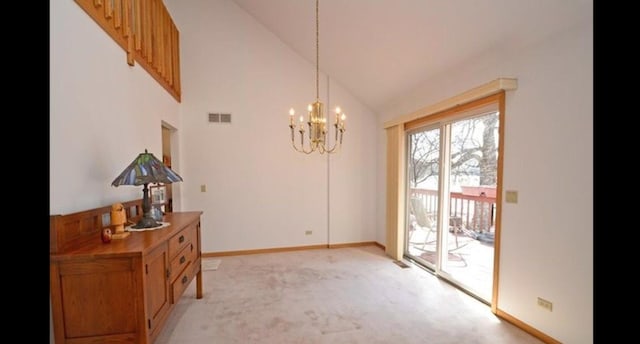 unfurnished dining area featuring light carpet, vaulted ceiling, baseboards, and a chandelier