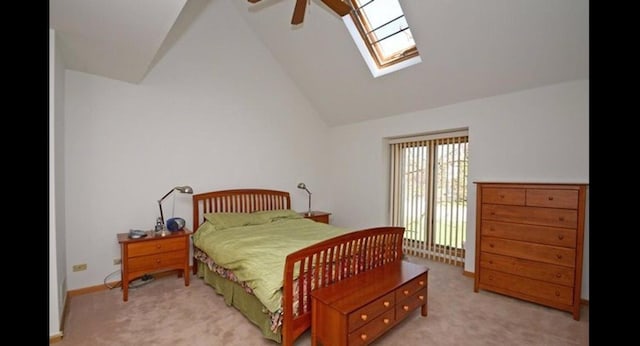bedroom featuring light colored carpet, a ceiling fan, and lofted ceiling with skylight