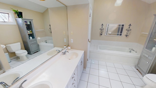 bathroom featuring a sink, toilet, double vanity, and a garden tub