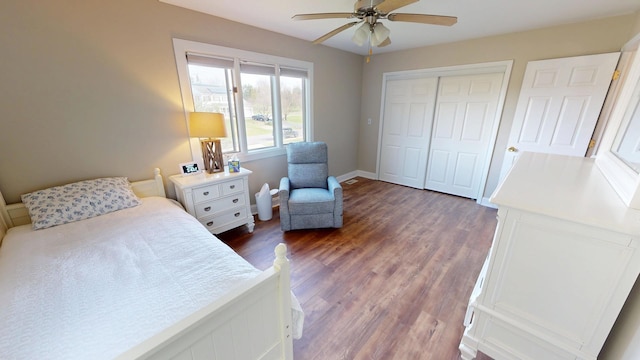 bedroom featuring dark wood-style flooring, a closet, ceiling fan, and baseboards
