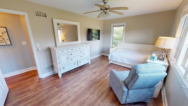 bedroom with visible vents, baseboards, a ceiling fan, and wood finished floors