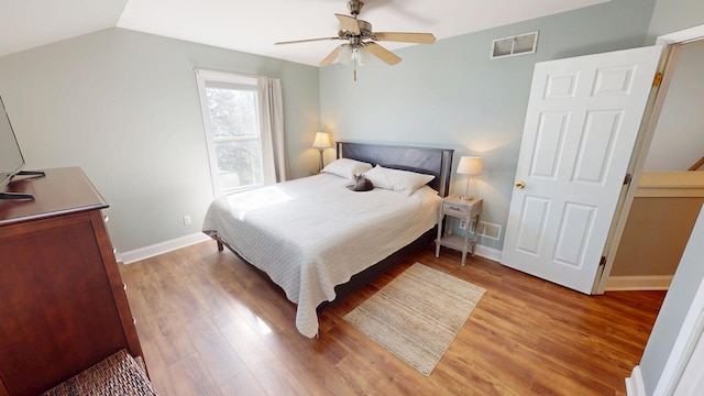 bedroom with visible vents, light wood-type flooring, baseboards, and a ceiling fan
