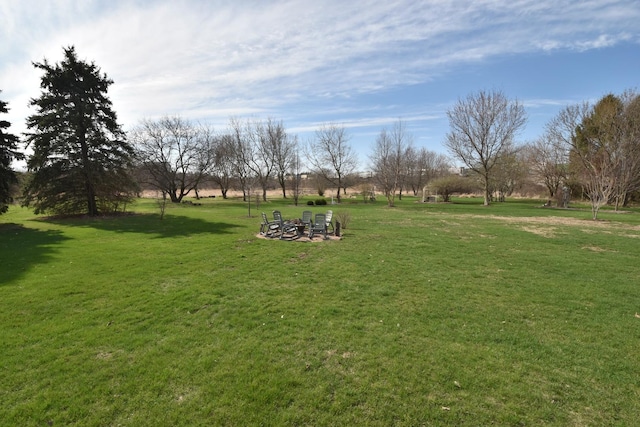 view of yard with an outdoor fire pit
