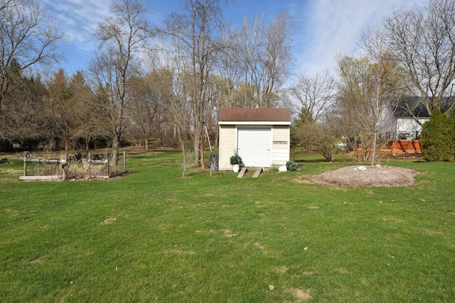 view of yard with a shed, a garden, and an outbuilding