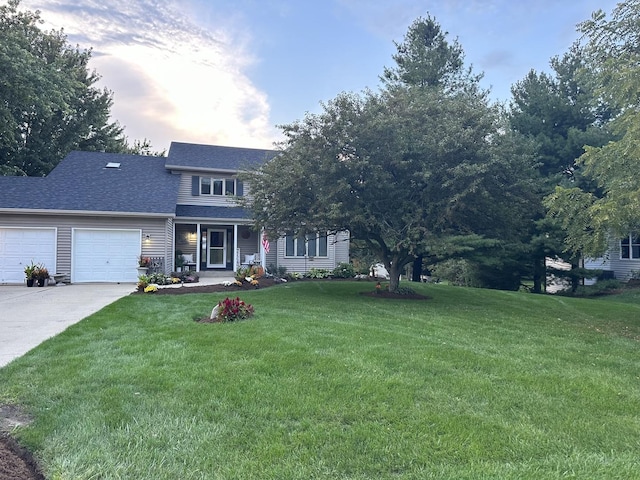 view of front of property featuring roof with shingles, a garage, a front yard, and concrete driveway
