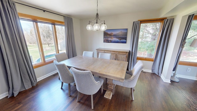 dining room with dark wood-type flooring, baseboards, and an inviting chandelier