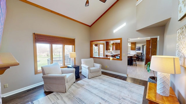 sitting room featuring visible vents, baseboards, high vaulted ceiling, and dark wood finished floors