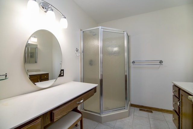 bathroom with a shower stall, tile patterned floors, visible vents, and vanity