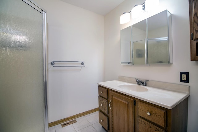 full bath with tile patterned floors, visible vents, vanity, and a shower with shower door