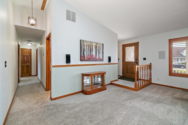 foyer featuring high vaulted ceiling, carpet, baseboards, visible vents, and electric panel